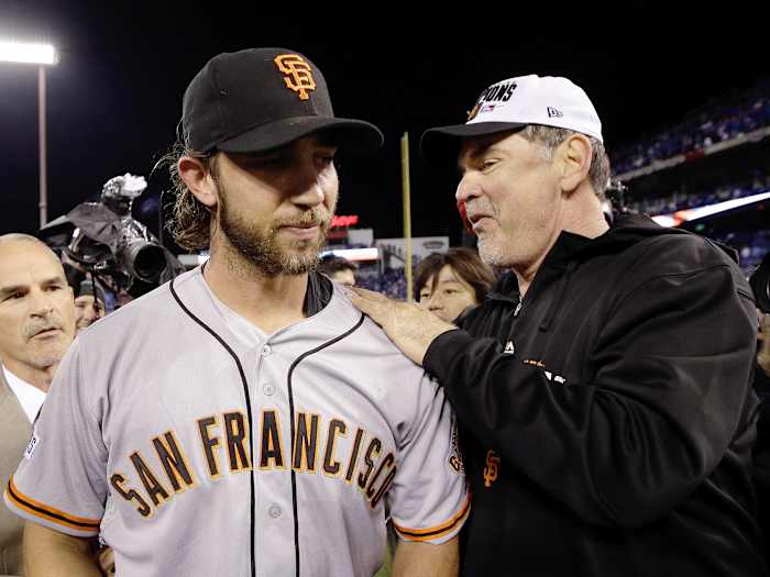 Manager Bruce Bochy #15 of the San Francisco Giants celebrates on the field with Madison Bumgarner #40 after defeating the Kansas City Royals 3-2 to win Game Seven of the 2014 World Series at Kauffman Stadium on October 29, 2014 in Kansas City, Missouri. (Photo by Ezra Shaw/Getty Images)